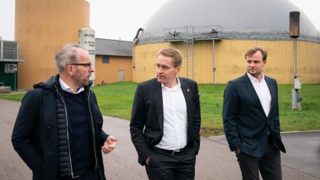 Ministerpräsident Daniel Günther ist im Gespräch mit einem Mann und läuft dabei durch eine Fabrikanlage.